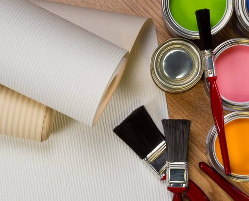 Paint brushes and open paint cans ready for a job